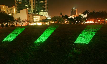 Emerald Laser Lawn, Dan Corson, 2007 Huzienga Plaza, Broward County, Florida, USA. Green lasers at low level playing out patterns across the lawn. Photo &copy; Dan Corson.