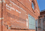 Electric Wharf site showing lettering on buildings, lead artist David Patten and Larry Priest of Bryant Priest Newman Architects. Electric Wharf, Coventry, 2001 - 2006. Photo: Larry Priest.