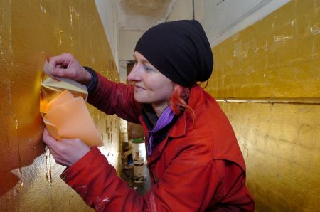 Artist Ginny Hutchison at work on her installation at No. 7 Kirk Street, Peterhead, March 2006. Photograph by Sans fa&ccedil;on.