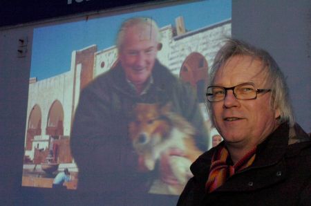 Film-maker Jean Bei Ning in front of his film projected onto the ice house in Peterhead, March 2006. Photograph by Sans fa&ccedil;on.