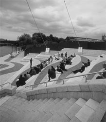 Artist Otiose describes his work 'Popular Territory' on the steps at Temple Quay. Photo: Stuart Bunce